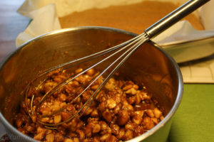 Combining the macadamia nuts in the caramel topping